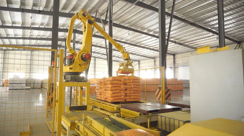 Robot palletizing line stacking bagged thermoplastic paint at the Hezhou base