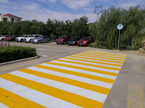Yellow and white zebra crossing applied on a municipal road