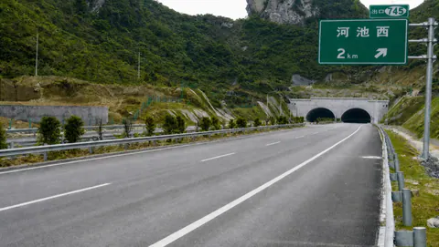 Lane markings leading into twin tunnel portals on the Hechi expressway
