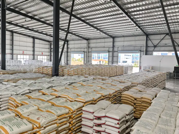 Finished-goods warehouse with palletized thermoplastic paint stacked at the loading bays