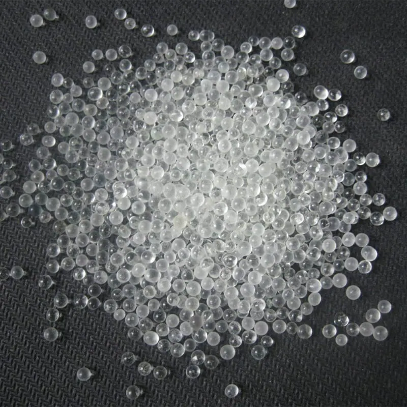 AASHTO M247 Type 2 reflective glass beads spread on a dark woven surface